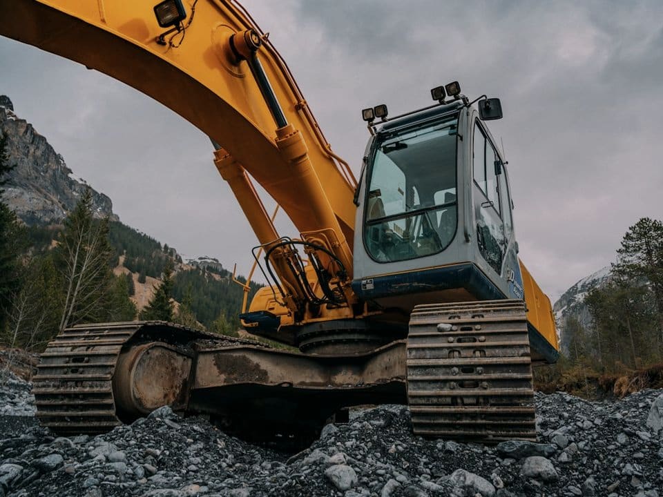 An excavator working in mountainous terrain